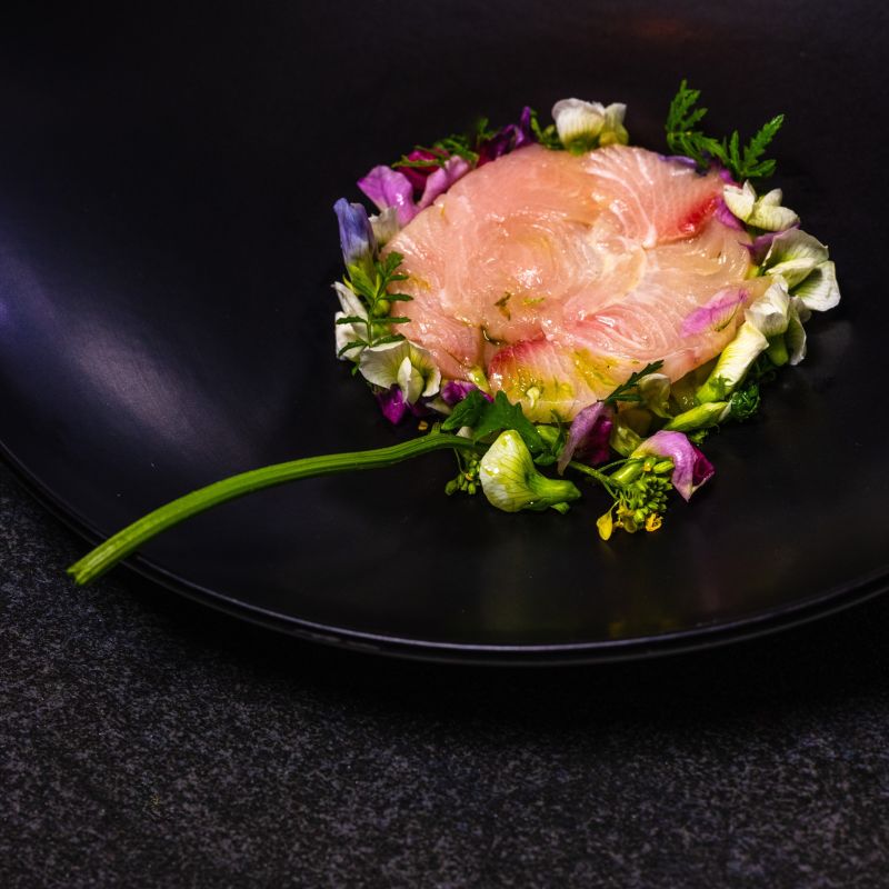 A Plate Of Food With A Purple Flower